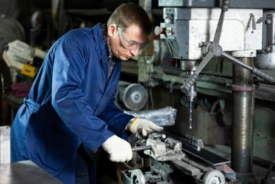 machinist working with industrial equipment